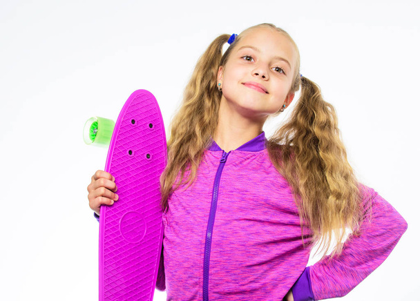 Child hold penny board. Kid long hair carry penny board. Plastic skateboards for everyday skater. Penny board of her dream. Best gifts for kids. Ultimate gift list help pick perfect present for girl - 写真・画像