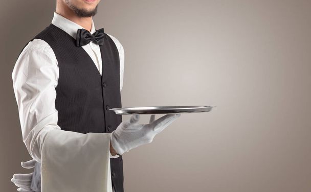 Waiter serving with white gloves and steel tray - 写真・画像