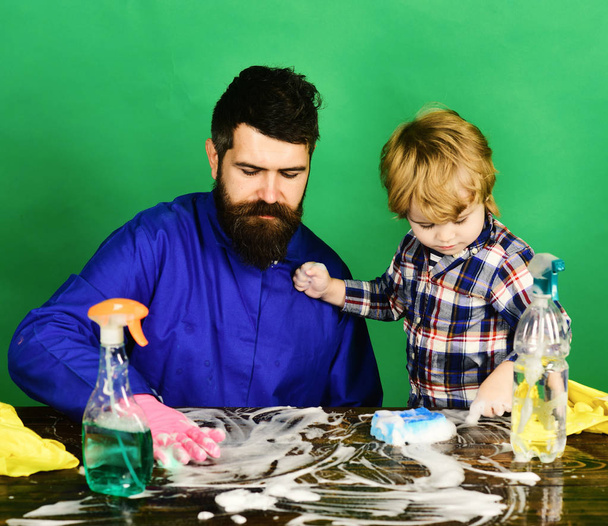 Man with beard and child in checkered shirt cleaning together. - Foto, Imagem