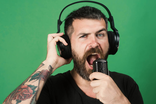 Relax and music concept. Man sings on green background. - Photo, image