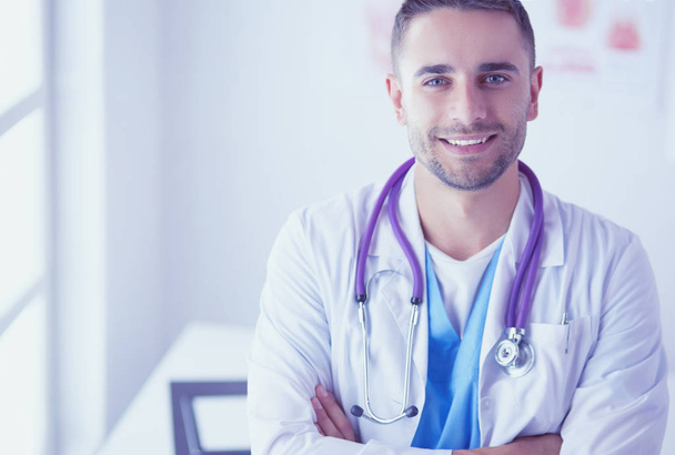 Young and confident male doctor portrait standing in medical off - Foto, Imagen