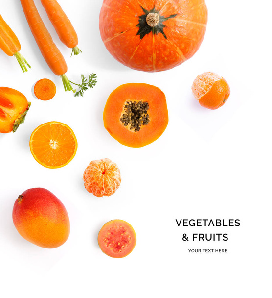 Creative layout made of orange vegetables and fruits. Flat lay. Food concept. Pumpkin,  papaya, orange, carrot, mango, guava, tangerine on the white background. - Foto, immagini