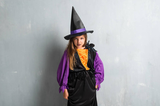Разъяренная маленькая девочка, одетая как ведьма на Хэллоуин праздников
 - Фото, изображение
