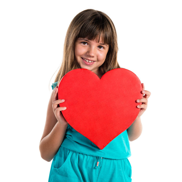 Young girl holding a heart - Fotoğraf, Görsel