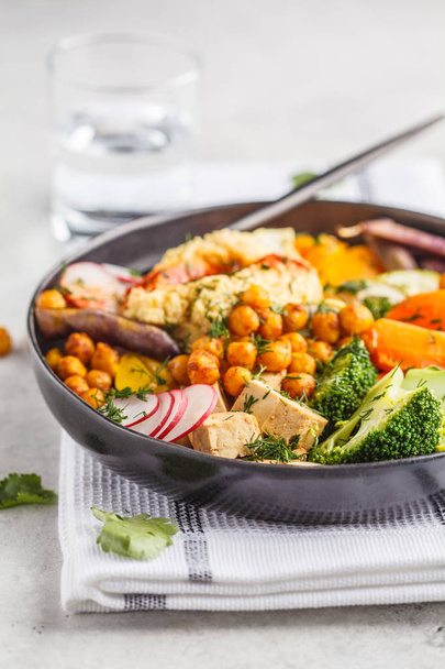 Vegan Buddha bowl with baked vegetables, chickpeas, hummus and tofu on white background. Detox, Clean eating concept. - Photo, Image