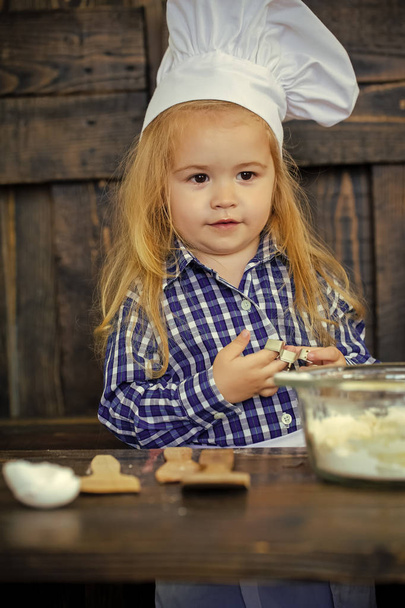 Baby cook in chef hat with cookie cutter - Φωτογραφία, εικόνα
