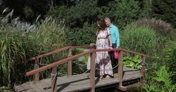 Young family on the wooden bridge - Кадры, видео