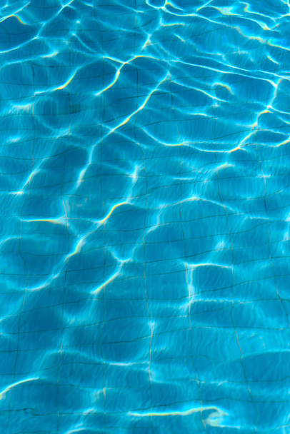 Vertical abstract background of azure water in the pool. - Photo, Image