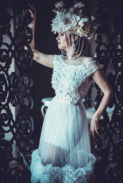Young beautiful bride standing in the palace room.  - 写真・画像