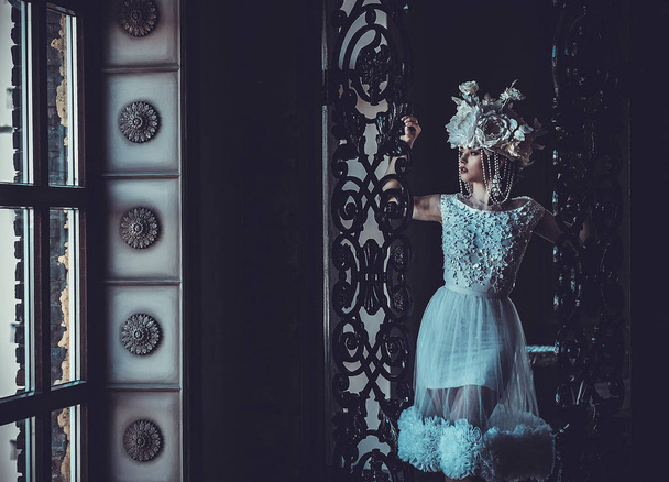 Young beautiful bride standing in the palace room.  - 写真・画像