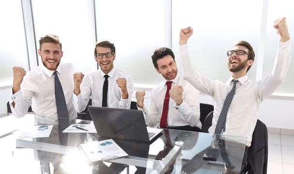very happy business team sitting at the Desk.the concept of a successful startup - 写真・画像