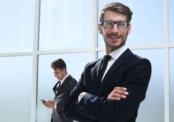 Portrait of joyful businessman against a office background - Фото, изображение