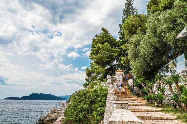 Hill near famous Sveti Stefan island near Budva during a beautiful summer day, Montenegr - 写真・画像