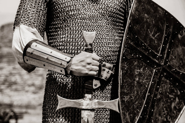 Knight man holding sword and shield. Image in black and white color style - Photo, Image