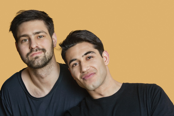 Portrait of young male friends over colored background - Foto, Imagem