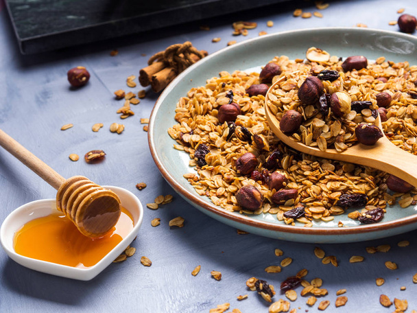 Homemade granola with honey and chestnuts on blue - Foto, immagini