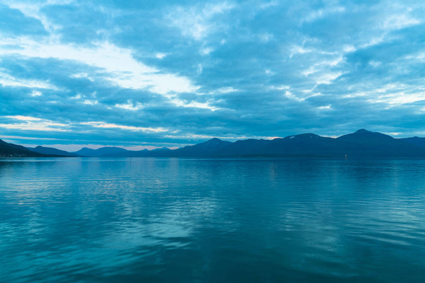 View of the fjord from Tromso on the island of Tromsoya at dusk, Norway - Photo, image