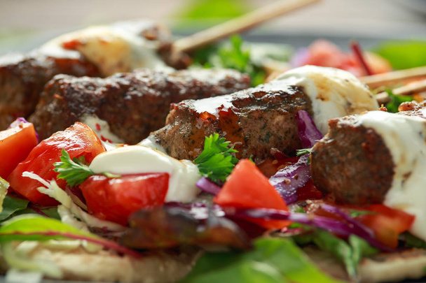 Lamb mint kebabs with flatbread, mix of vegetables, lime and greek yoghurt chilli sauce. - Photo, Image