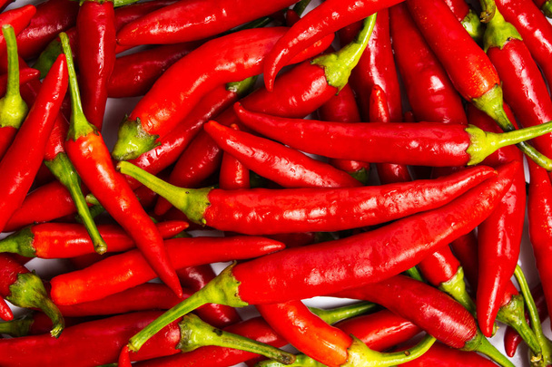 Thin red peppers on a pile making background - Foto, afbeelding