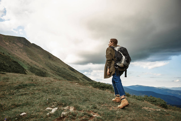 Enthusiastic woman carrying backpack while traveling alone - Photo, image