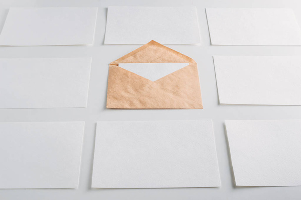 White paper empty sheets cards and kraft envelope on a white background. Mockup for design - Photo, Image