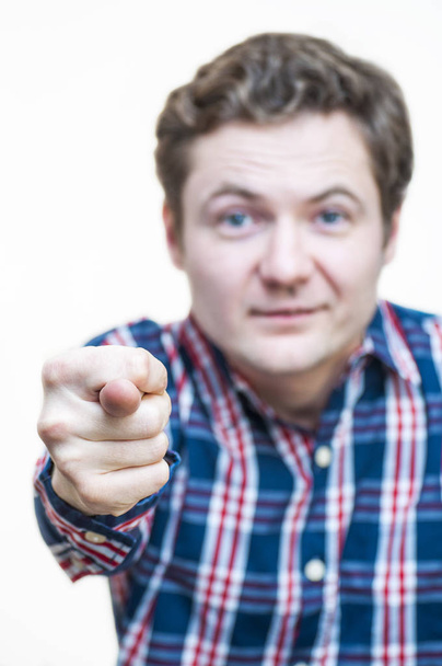 Retrato de jovem caucasiano Etnia engraçada homem mostrando mão sinal gesto obsceno, polegar dedo no fundo branco
. - Foto, Imagem