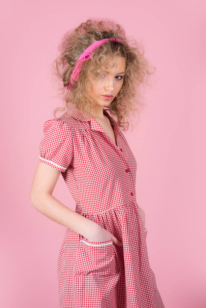 Pinup girl vintage with curly hair. Pretty woman pinup style in retro fashion dress. Curly is beautiful - 写真・画像