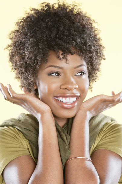 Happy African American woman looking away over colored background - 写真・画像