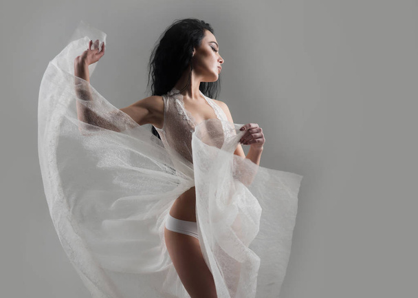 sexy woman. sexy woman in white dress. woman in transparent dress, copy space. sexy woman in fashionbale fly dress. stylish and sexy - Foto, afbeelding