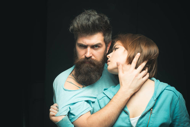 She likes his soft beard. Women love bearded brutal and masculine guys. Hipster bearded cuddling sensual girl. Make hair soft with oils and moisturizing conditioner. Hair care and barbershop concept - Photo, image