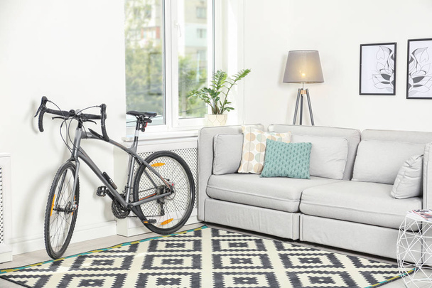 Modern living room interior with bicycle near wall - Foto, imagen