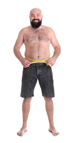 Full length portrait of fat man with measuring tape on white background. Weight loss - Foto, Imagem