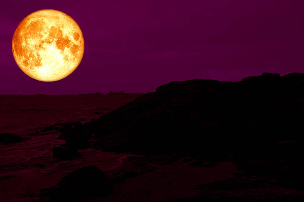 blood pink moon back silhouette rock mountain on coast, Elements of this image furnished by NASA - Photo, Image