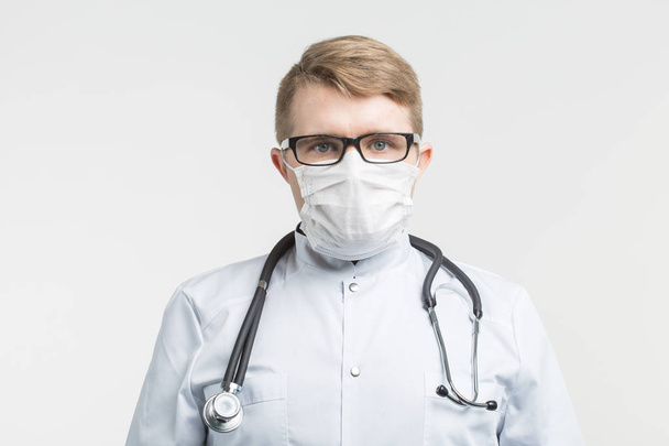 Health and medicine - doctor wearing the stethoscope and white mask on white background - Fotografie, Obrázek