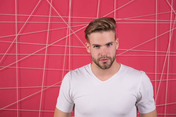 Simple hacks to make hairstyle better. Use right product styling hair. Confident with tidy hairstyle. Barber hairstyle tips. Man bearded guy modern hairstyle in pensive mood pink background - Zdjęcie, obraz