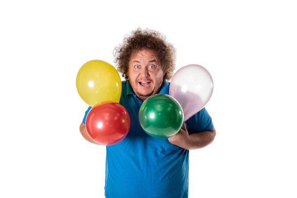Funny fat man with balloons. Happy birthday. Joy and fun - 写真・画像