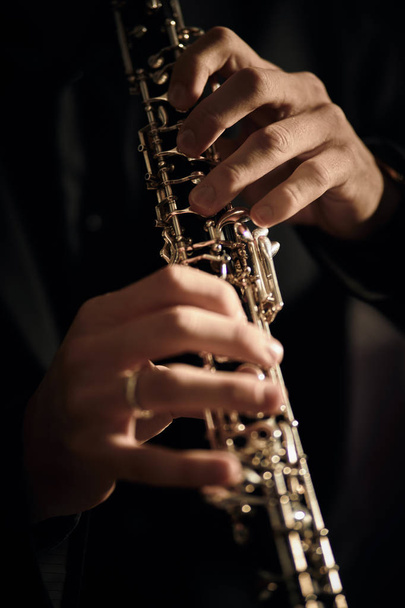 Oboe player on black background - Foto, Imagem