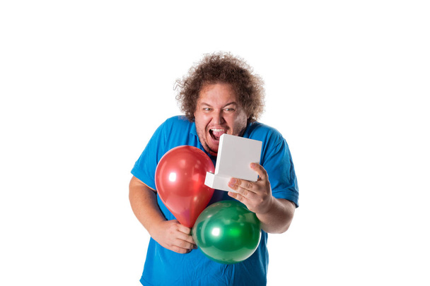 Funny fat man with gift and balloons. Happy birthday. Joy and fun - Zdjęcie, obraz
