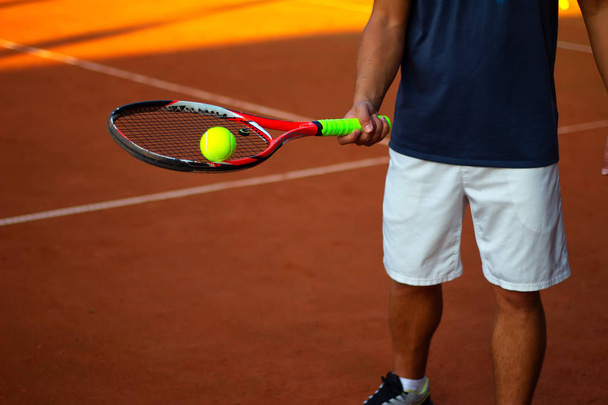 Man holding tennis ball close-up on - Fotografie, Obrázek