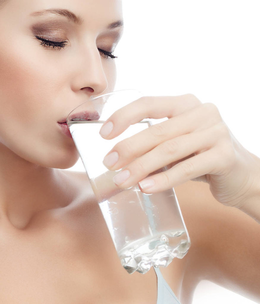 portrait of attractive  caucasian woman isolated on white studio shot drinking water - Foto, immagini