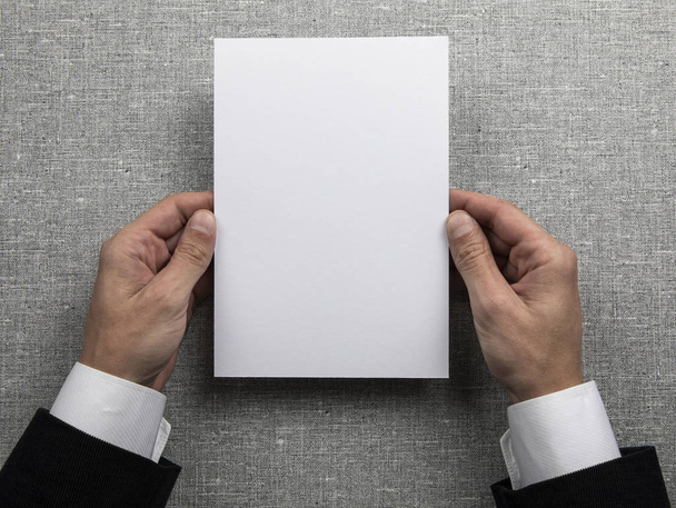 Mens hands holding empty white letterhead  - Foto, imagen