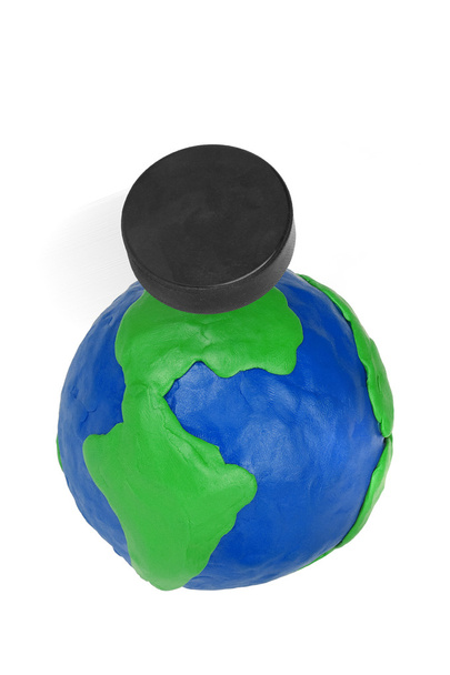 Plasticine globe and hockey puck - Foto, Imagen