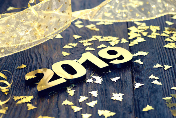 Happy New Year 2019. Symbol from number 2019 on wooden background - Photo, Image
