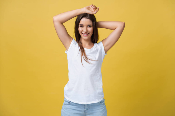 Image of excited young woman standing isolated over yellow background. Looking camera. - Fotografie, Obrázek