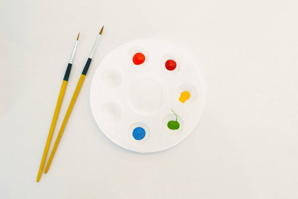Multicolored watercolor in a round white plastic tray. - Photo, Image