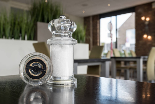 na stole v restauraci jsou pepř a sůl mlýnek - Fotografie, Obrázek