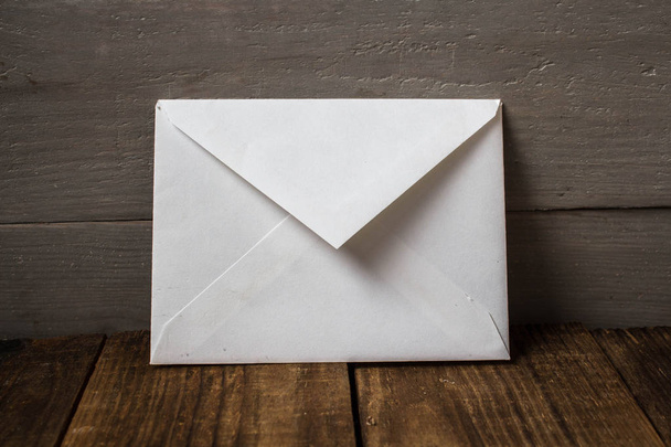 white envelope on grey wooden background - Foto, Bild
