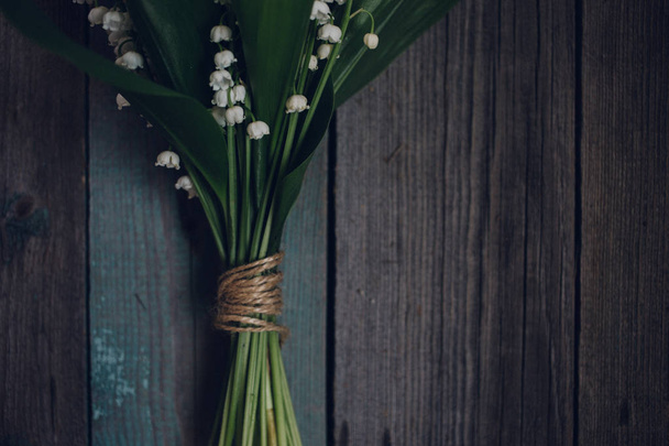 Lily of the Valley on old wooden background - 写真・画像