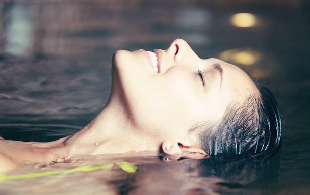 Woman relaxing in a spa, smiling  - Фото, зображення