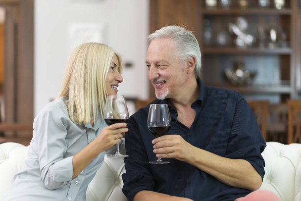 Portrait of a mature couple drinking a glass of red wine 4k - Foto, afbeelding
